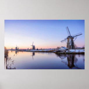 Windmills during a sunrise in Holland poster
