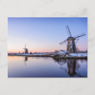 Windmills in winter during a sunrise postcard
