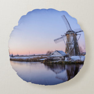 Windmills in winter during a sunrise round pillow