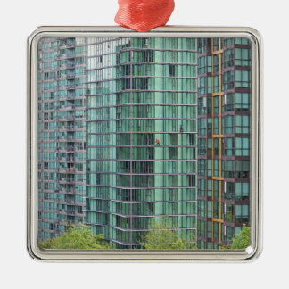 Window washers on downtown high rise building metal ornament
