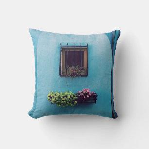 WINDOW WITH FRAME ABOVE GREEN AND PINK PETALED FLO CUSHION