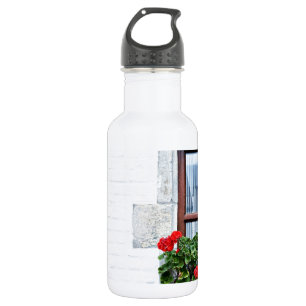window with red flowers on white wall 532 ml water bottle