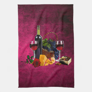 Wine glasses, bottle, grapes, cheese, chacolates tea towel