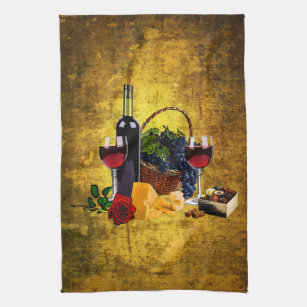 Wine glasses, bottle, grapes, cheese, chacolates tea towel