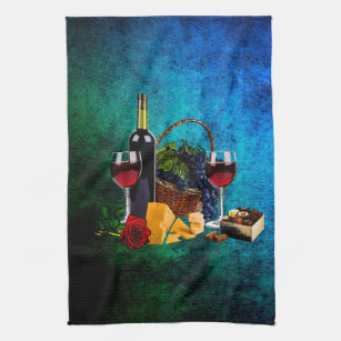 Wine glasses, bottle, grapes, cheese, chocolates tea towel