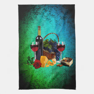 Wine glasses, bottle, grapes, cheese, chocolates tea towel