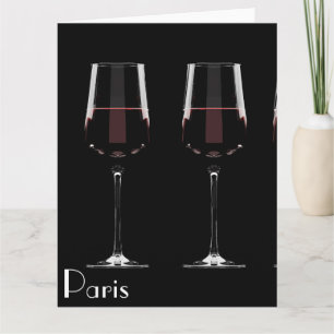Wine glasses with red wine on black card