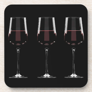 Wine glasses with red wine on black coaster