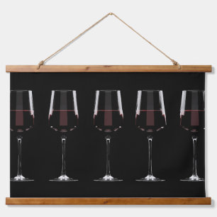Wine glasses with red wine on black hanging tapestry