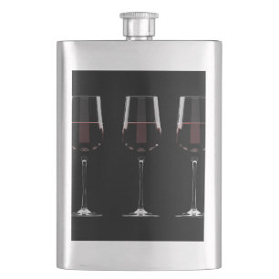 Wine glasses with red wine on black hip flask