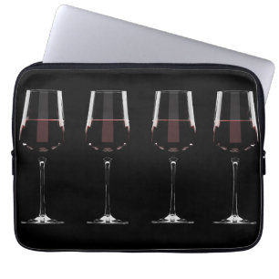 Wine glasses with red wine on black laptop sleeve