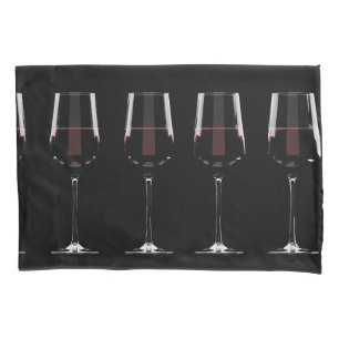 Wine glasses with red wine on black pillowcase