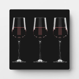 Wine glasses with red wine on black plaque