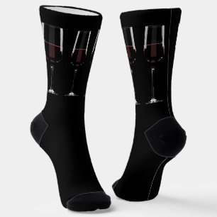 Wine glasses with red wine on black socks