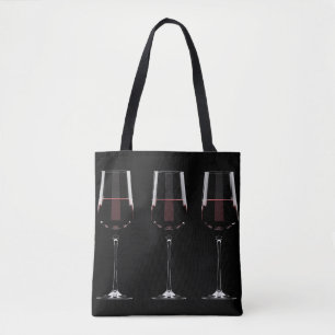 Wine glasses with red wine on black tote bag