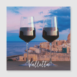 Wine glasses with view of sunset over Valletta