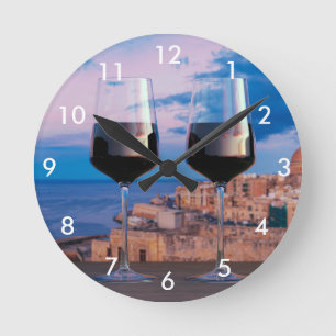 Wine glasses with view of sunset over Valletta Round Clock