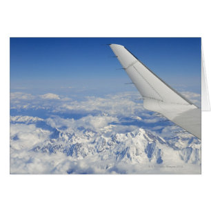 Wings of flying aeroplane over French Alps,