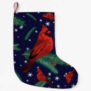 Winter birds - cardinals on fir-tree branches with small christmas stocking