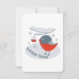 Winter bullfinch bird and red rowan berries
