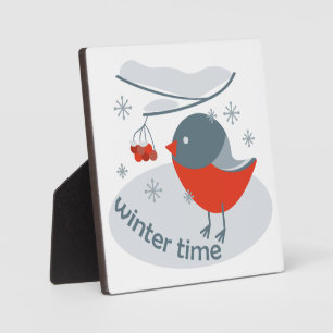 Winter bullfinch bird and red rowan berries plaque