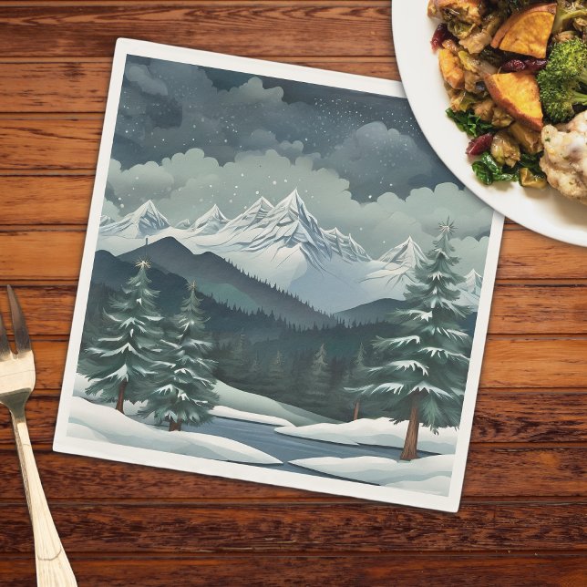 Winter Forest Mountain Scene Napkin (A mountain scene on a napkin that is on a wooden table with a plate of food and a fork)