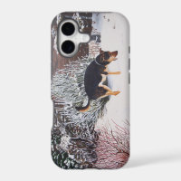 Winter snow scene with cute black and tan dog