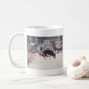 Winter snow scene with cute black and tan dog coffee mug