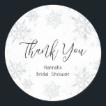 Winter Snowflakes Thank You Classic Round Sticker<br><div class="desc">"Thank You" in a fun script with event name framed by watercolor snowflakes in silver faux glitter. Coordinates with the Glitter Snowflake collection found in the Adore Paper Co. Zazzle Shop.</div>