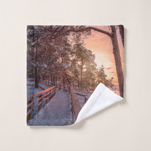 Winter sunset in pine forest near sea wash cloth