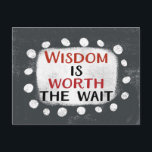 Wisdom Is Worth The Wait Postcard<br><div class="desc">Bold text reading "Wisdom Is Worth The Wait" is centred against a grey background. The black and red text sits on a white rectangle with large textured white dots around it,  providing a playful contrast against the solid colour backdrop.</div>