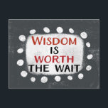 Wisdom Is Worth The Wait Postcard<br><div class="desc">Bold text reading "Wisdom Is Worth The Wait" is centred against a grey background. The black and red text sits on a white rectangle with large textured white dots around it,  providing a playful contrast against the solid colour backdrop.</div>