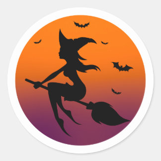 Witch silhouette in orange moon classic round sticker