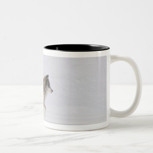Wolf running in the snow 2 Two-Tone coffee mug (Right)