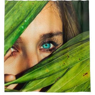 Woman behind green leaves shower curtain