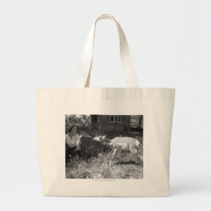 Woman bottle feeding an antelope. large tote bag