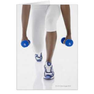 Woman doing lunges with dumbbells (low section)