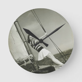 Woman Holding Rigging on Yacht Round Clock