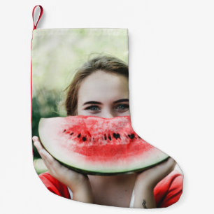 Woman holding sliced watermelon small christmas stocking