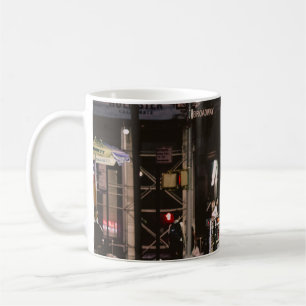 WOMAN IN BLACK AND RED DRESS WALKING BESIDE BROWN COFFEE MUG