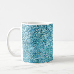 Woman in black bikini bottom and white sun hat sta coffee mug