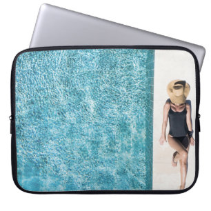 Woman in black bikini bottom and white sun hat sta laptop sleeve