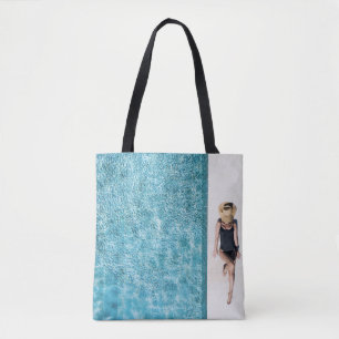 Woman in black bikini bottom and white sun hat sta tote bag