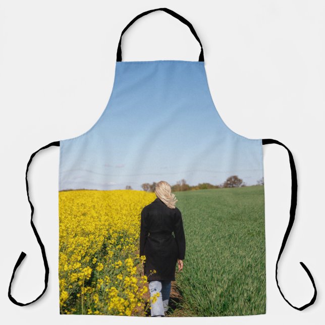 Woman in black coat standing on green grass field  apron (Front)