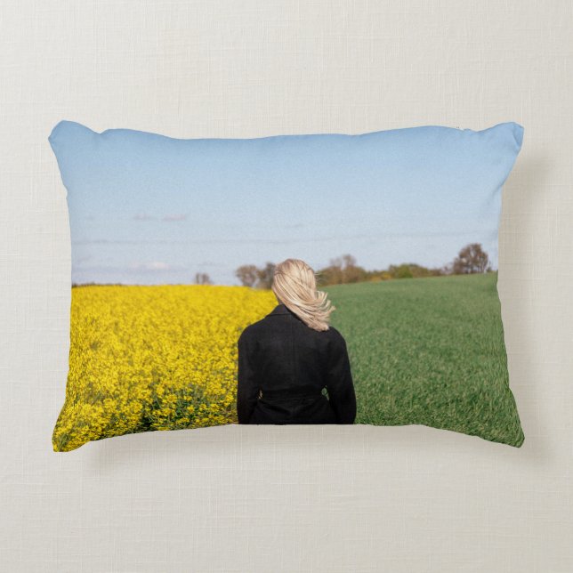 Woman in black coat standing on green grass field  decorative cushion (Front)