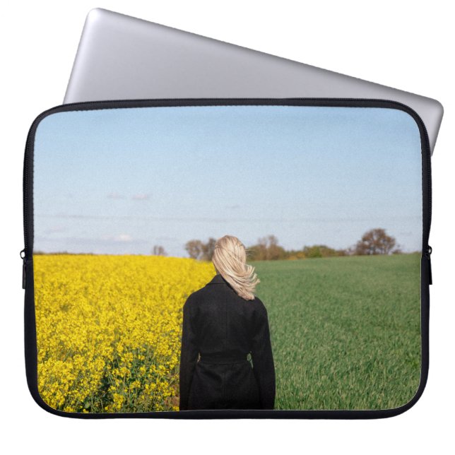 Woman in black coat standing on green grass field  laptop sleeve (Front)