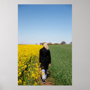 Woman in black coat standing on green grass field  poster