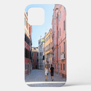 Woman in black jacket walking on sidewalk in the m iPhone 12 case