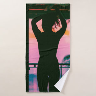 Woman in black tank top and pants standing on blac bath towel