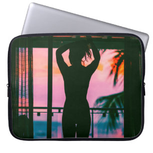 WOMAN IN BLACK TANK TOP AND PANTS STANDING ON BLAC LAPTOP SLEEVE